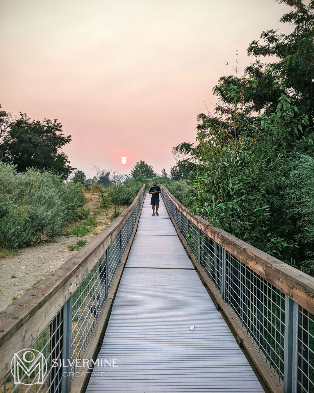 Man on a bridge, smoky sunset